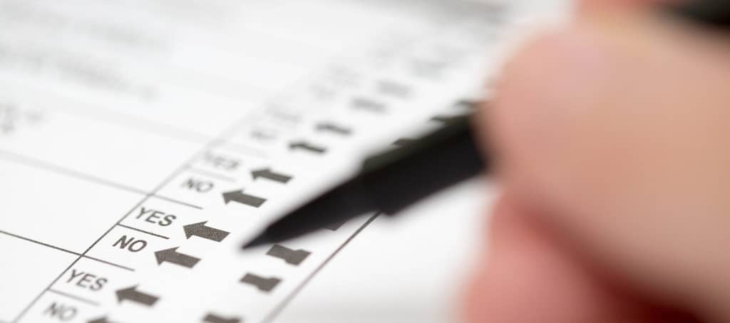 Voter preparing to make selections on ballot propositions
