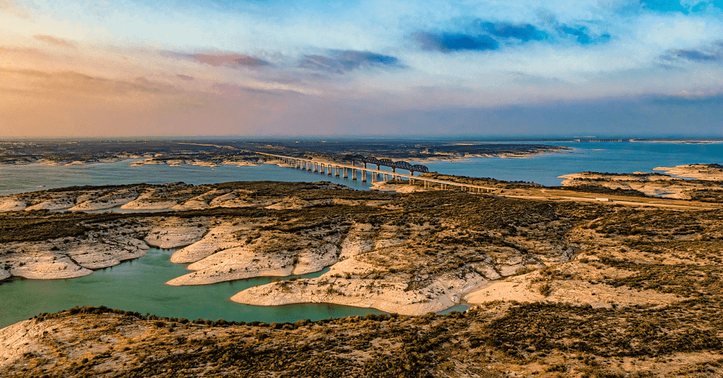 Aerial view of Amistad Reservoir with the Governor's Landing Bridge in Texas at sunset