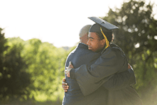 New graduate hugging his father
