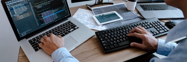 Laptop and two keyboards image