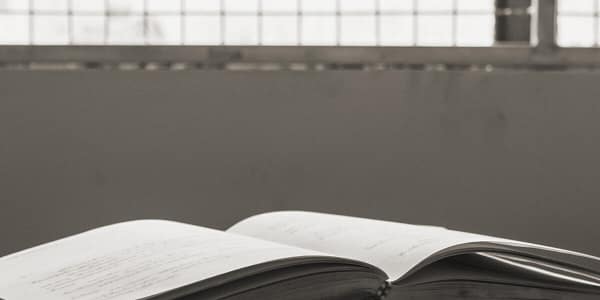Books open on a table in a prison
