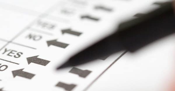 Voter preparing to make selections on ballot propositions