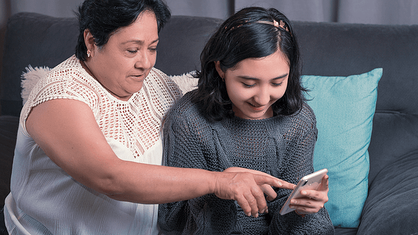 A young woman showing her grandmother how to use the internet