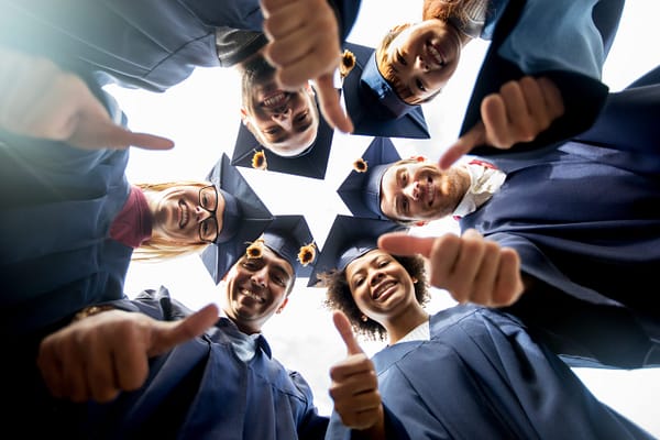 Graduates giving thumbs up