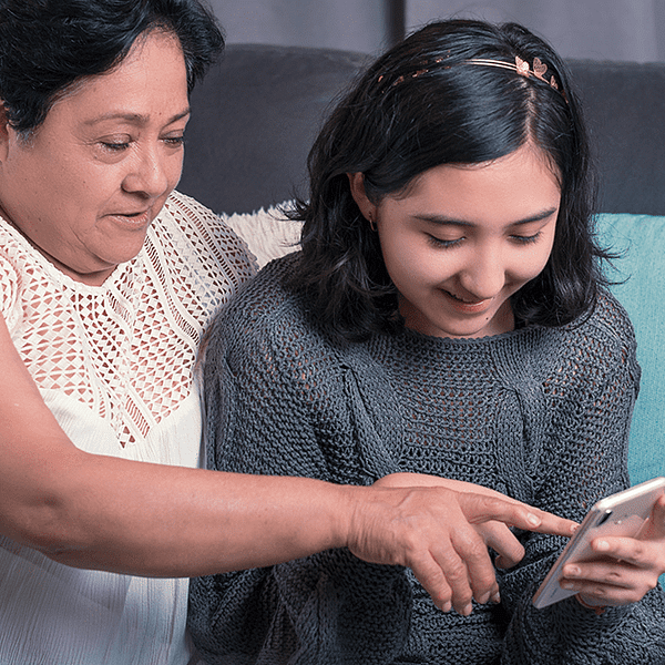 A young woman showing her grandmother how to use the internet