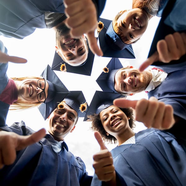 Graduates giving thumbs up