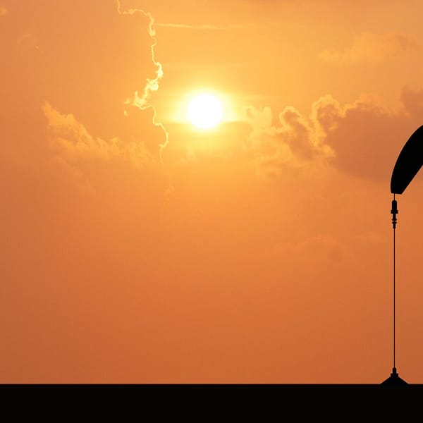 Oil pump with sun in the background.