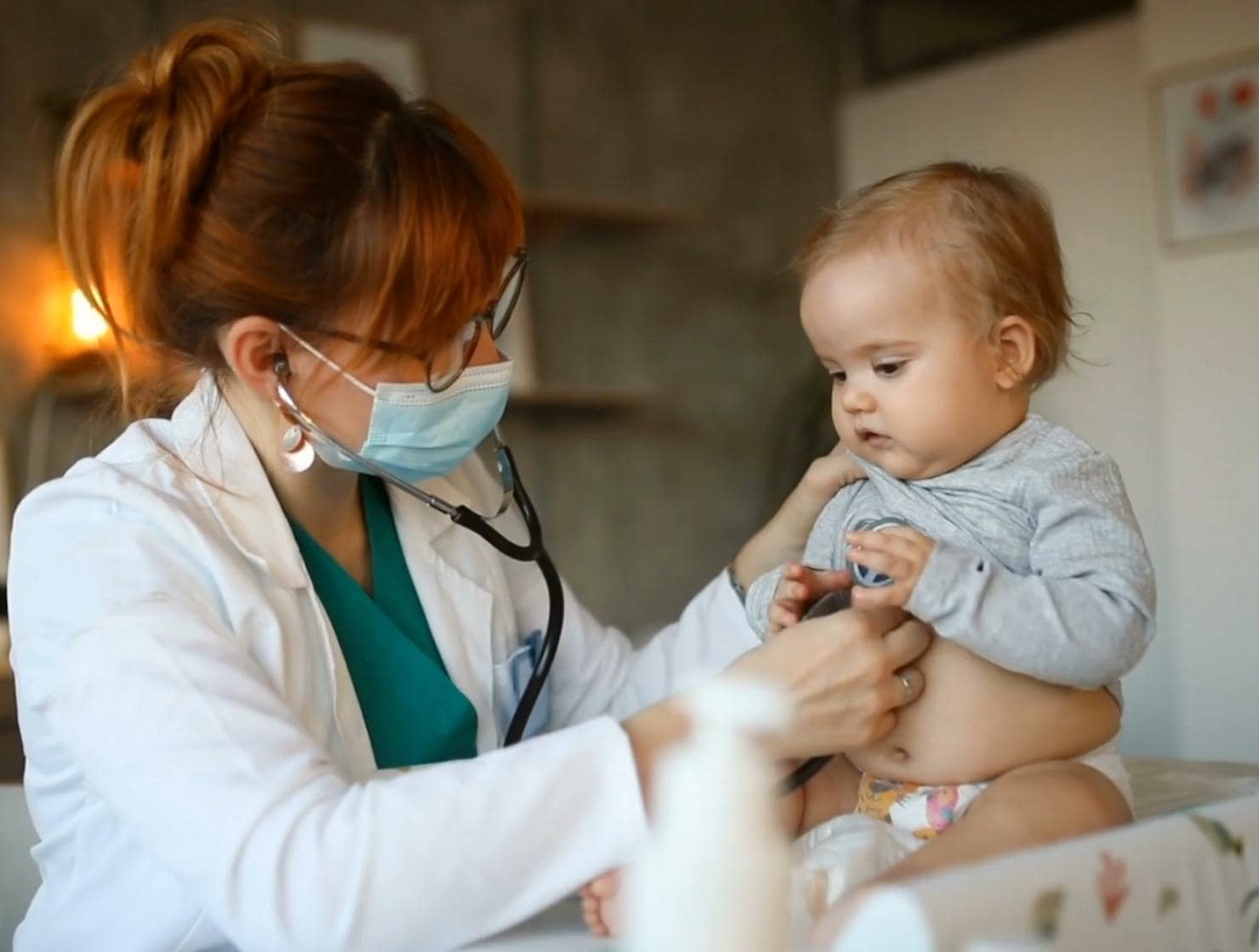 Pediatrician examining infant